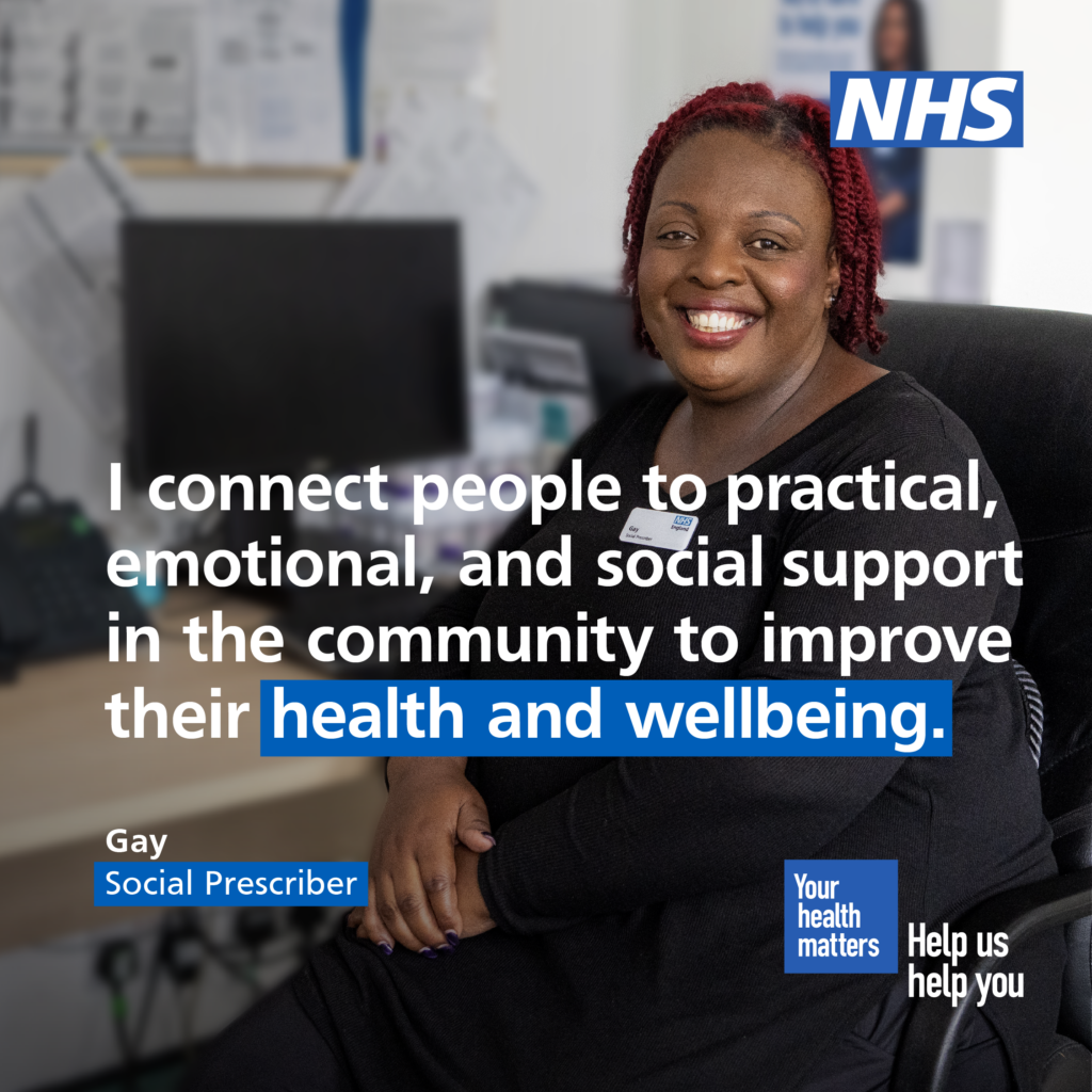 Gay, a social prescriber, is sat at a desk. The body text reads: 'I connect people to practical, emotional, and social support in the community to improve their health and wellbeing.' 

The NHS logo features in the top right corner.