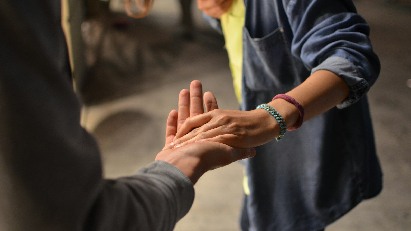 man and woman holding hands on street