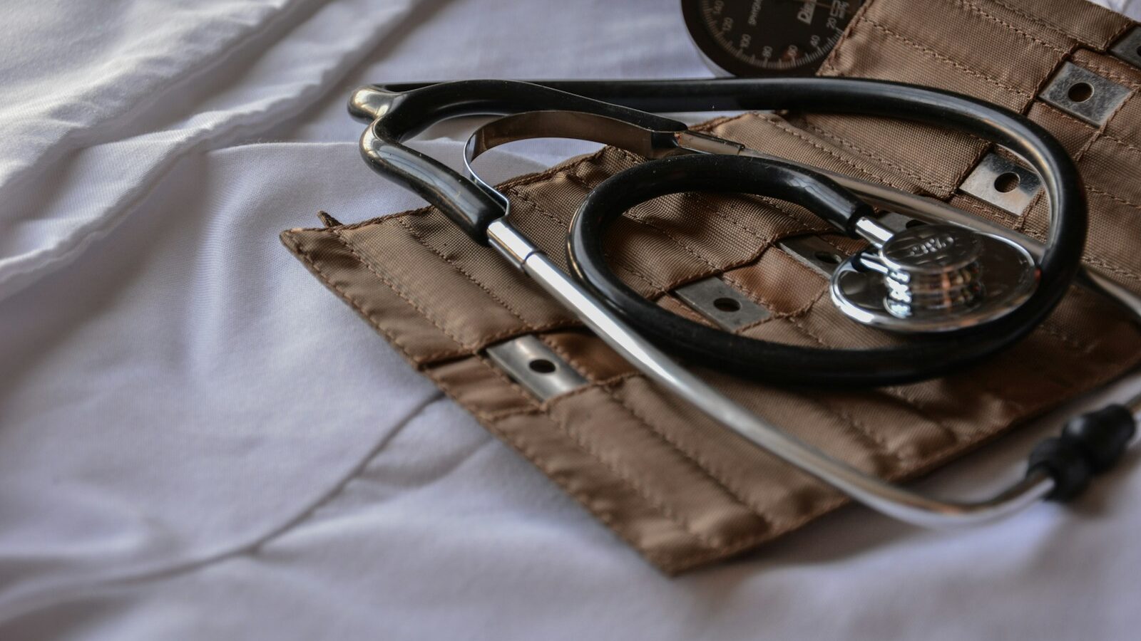 black stethoscope with brown leather case