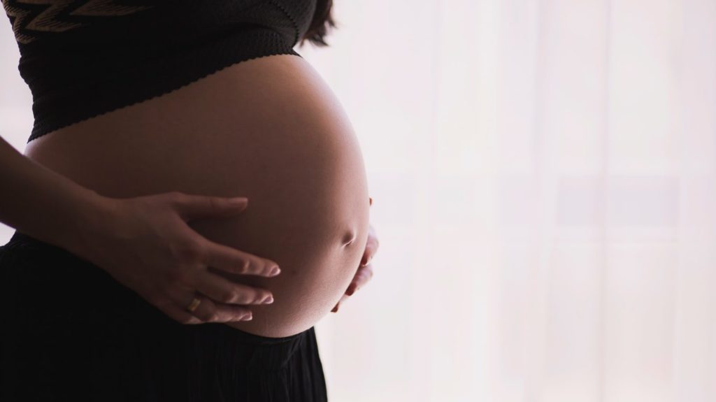 woman holding stomach