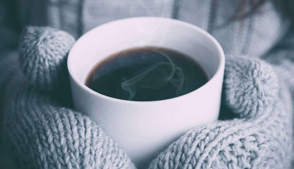 person holding white ceramic mug