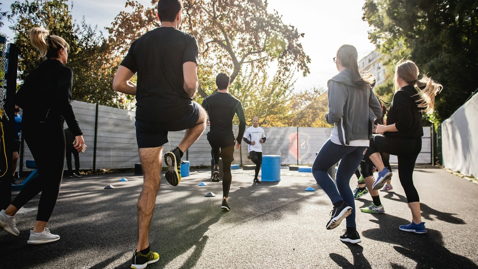 man in black t-shirt and black shorts running on road during daytime