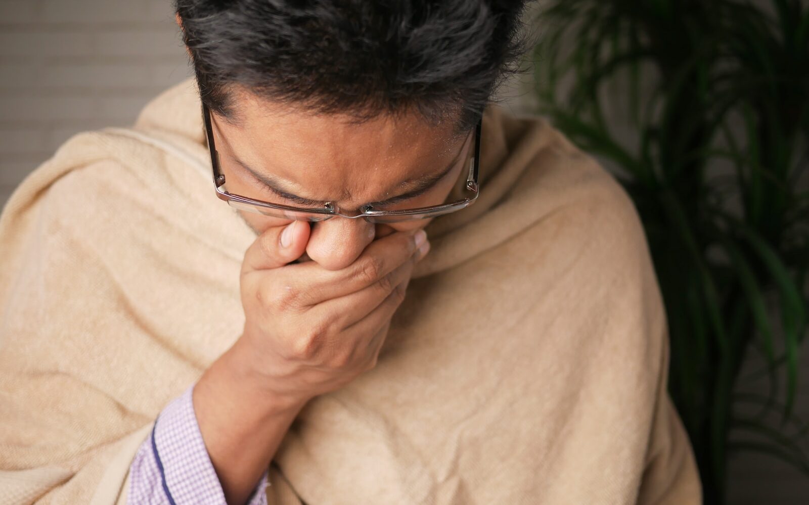 man in brown sweater wearing black framed eyeglasses