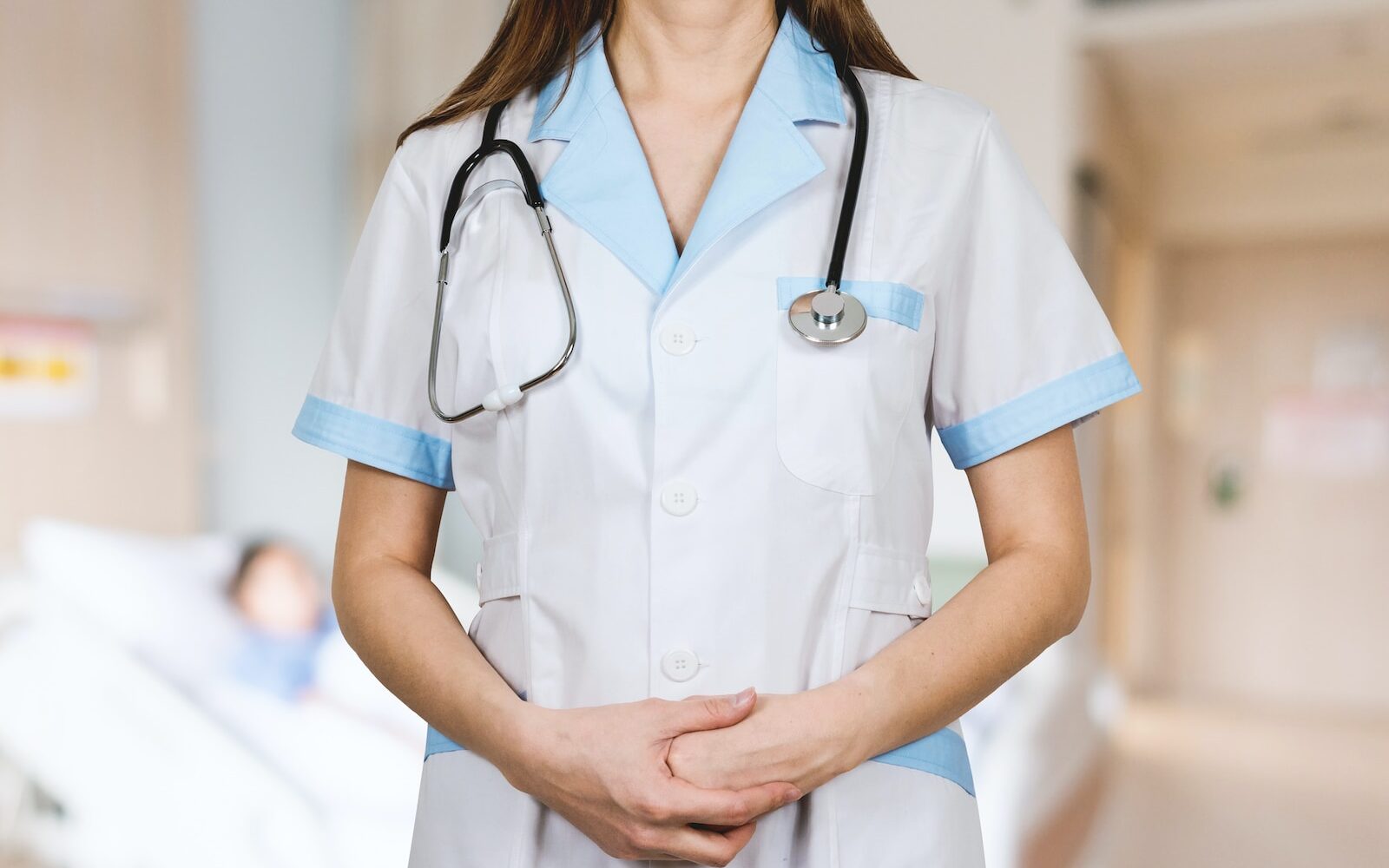 woman in white button up shirt and blue stethoscope