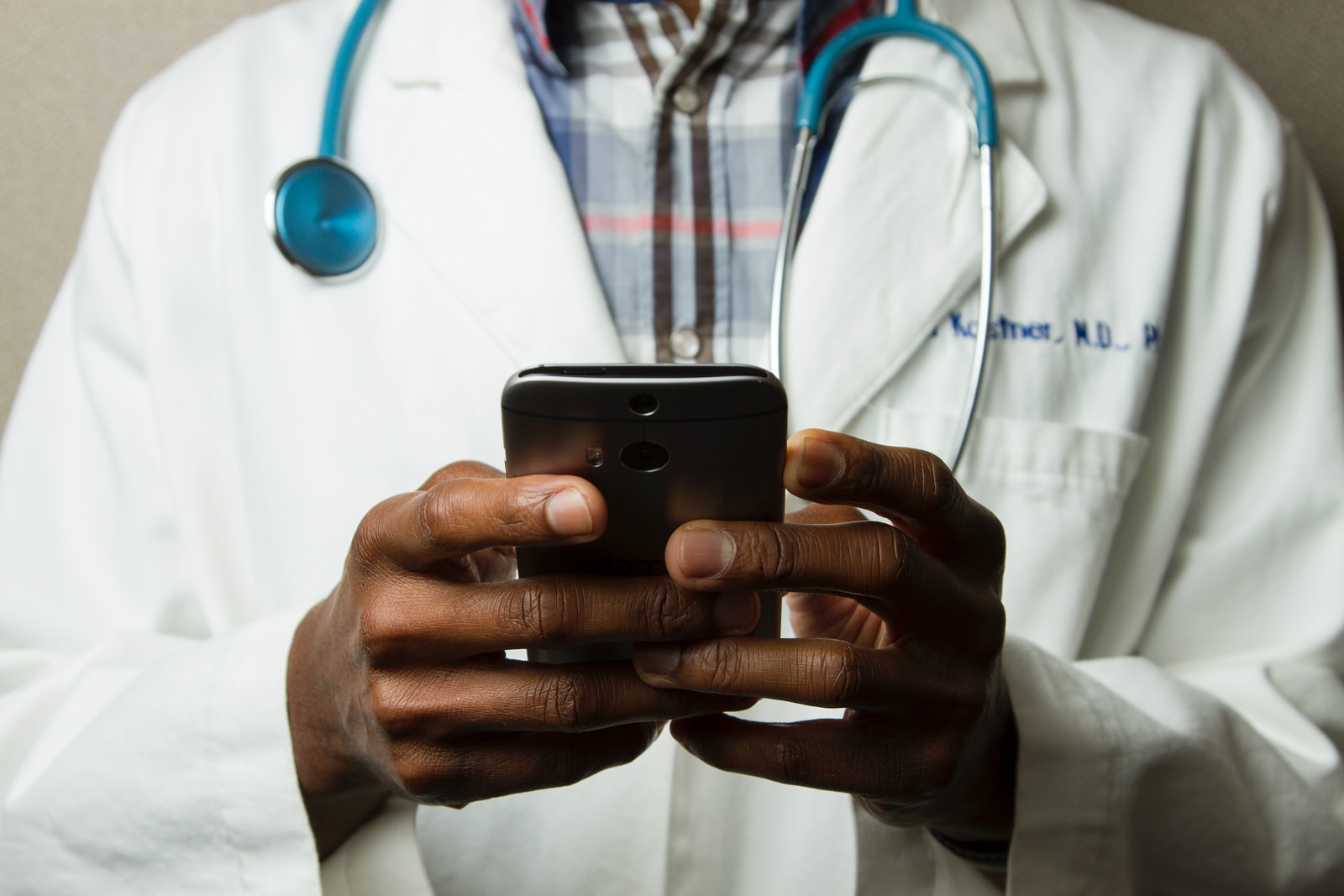 doctor holding red stethoscope