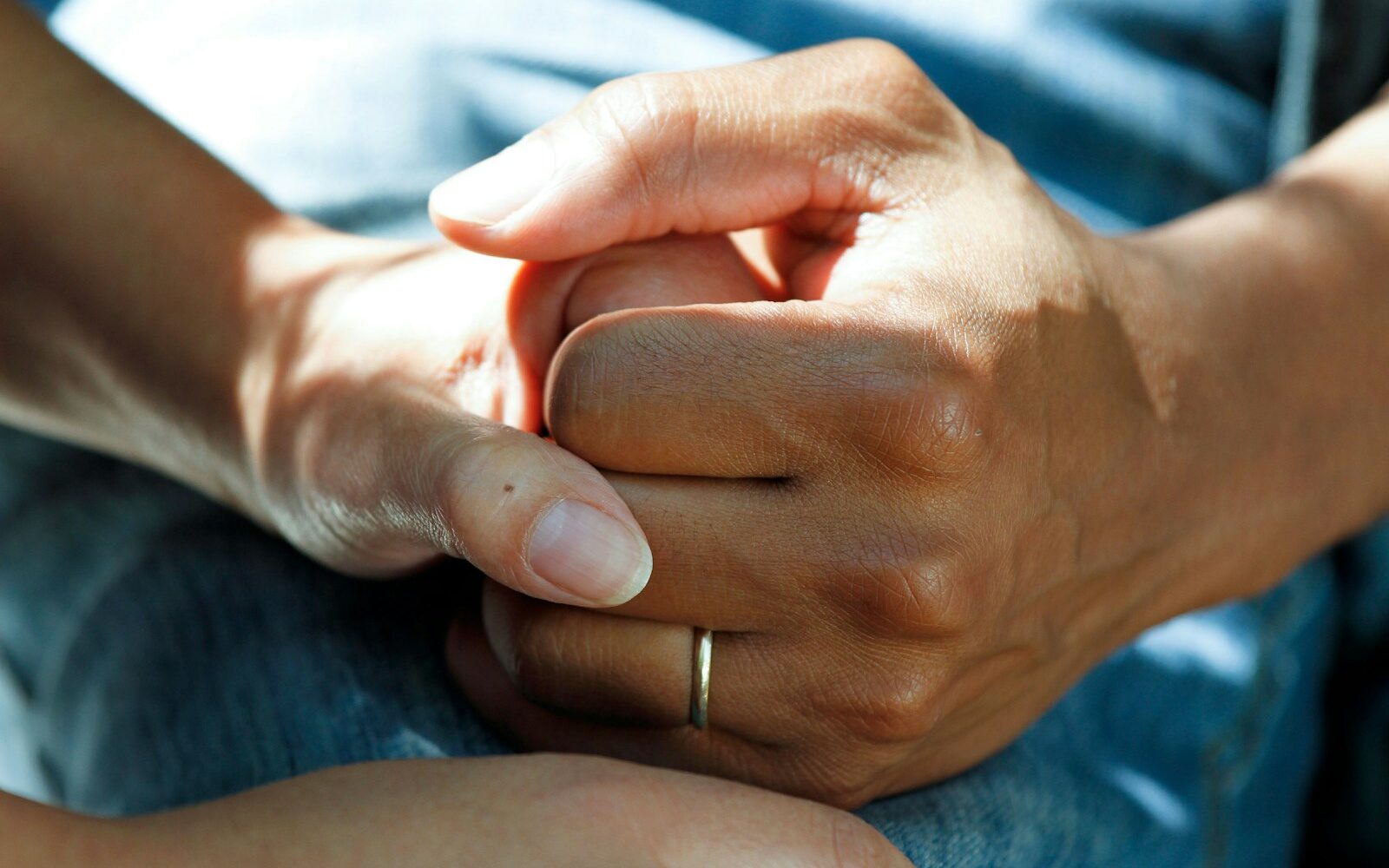 person wearing gold wedding band