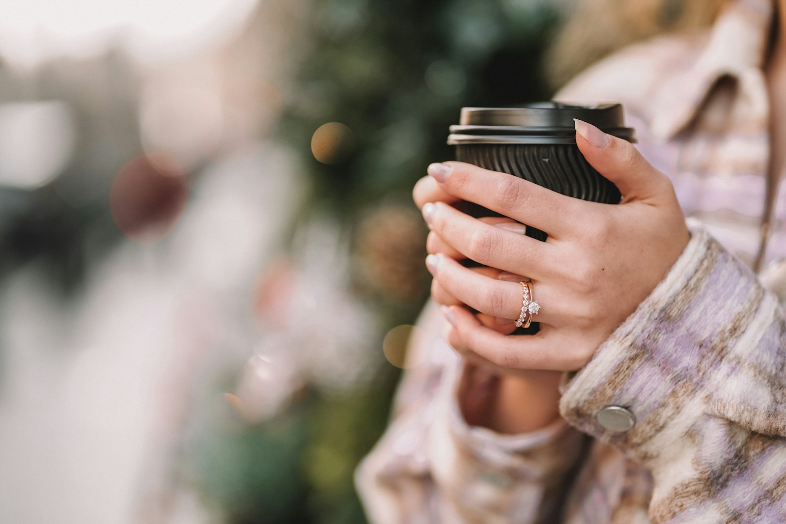 a woman holding a coffee cup in her hands