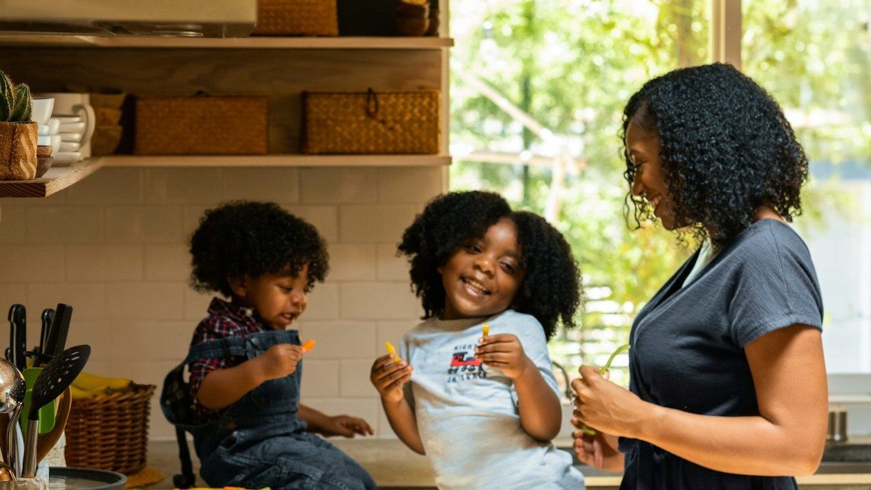 woman in white t-shirt standing beside woman in black and white stripe shirt