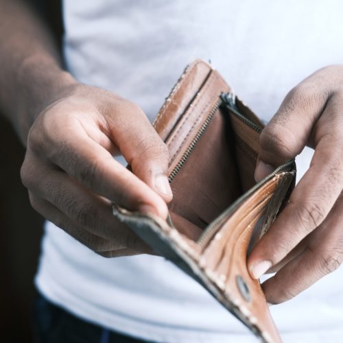 person holding brown leather bifold wallet