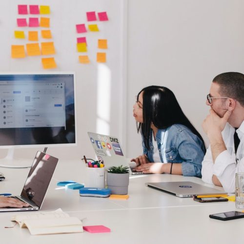 five person by table watching turned on white iMac