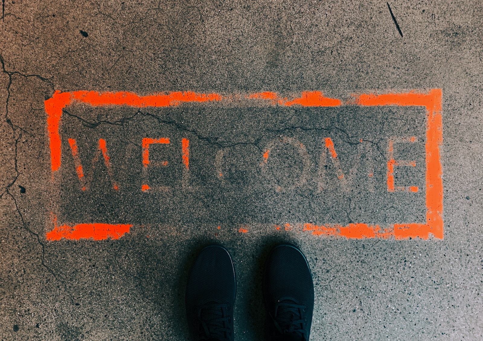 a person standing in front of a welcome sign