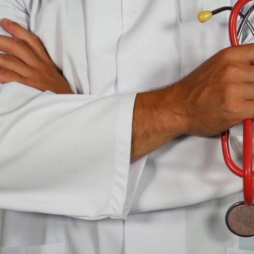 doctor holding red stethoscope