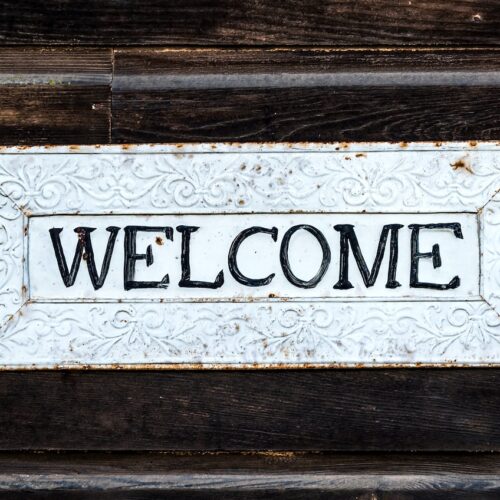 black and white wooden welcome signage