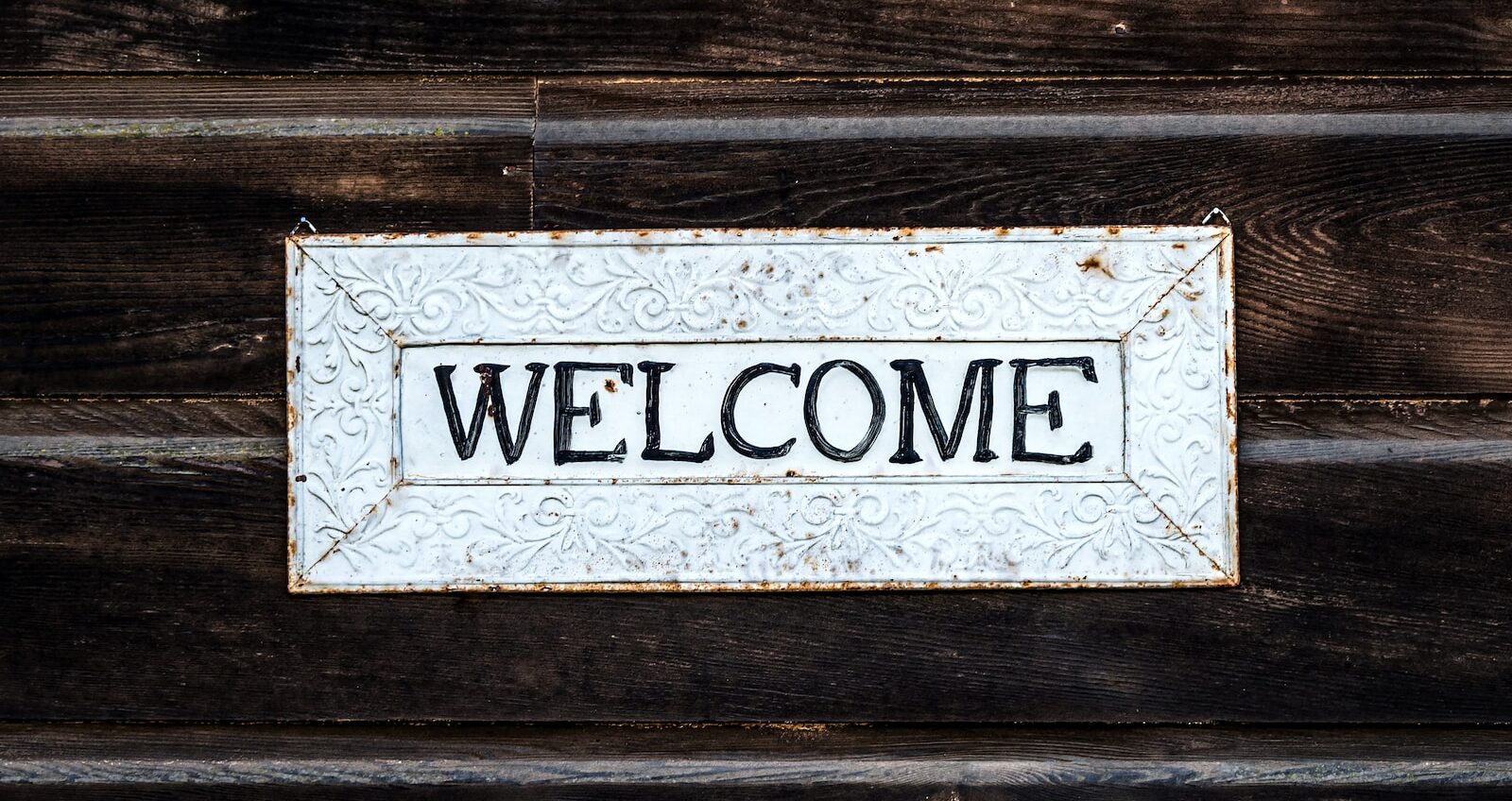 black and white wooden welcome signage