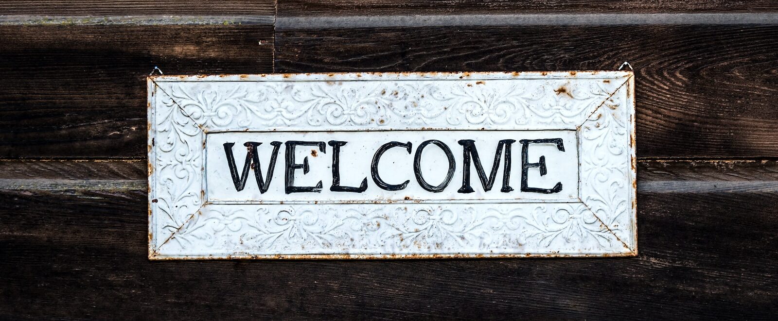 black and white wooden welcome signage