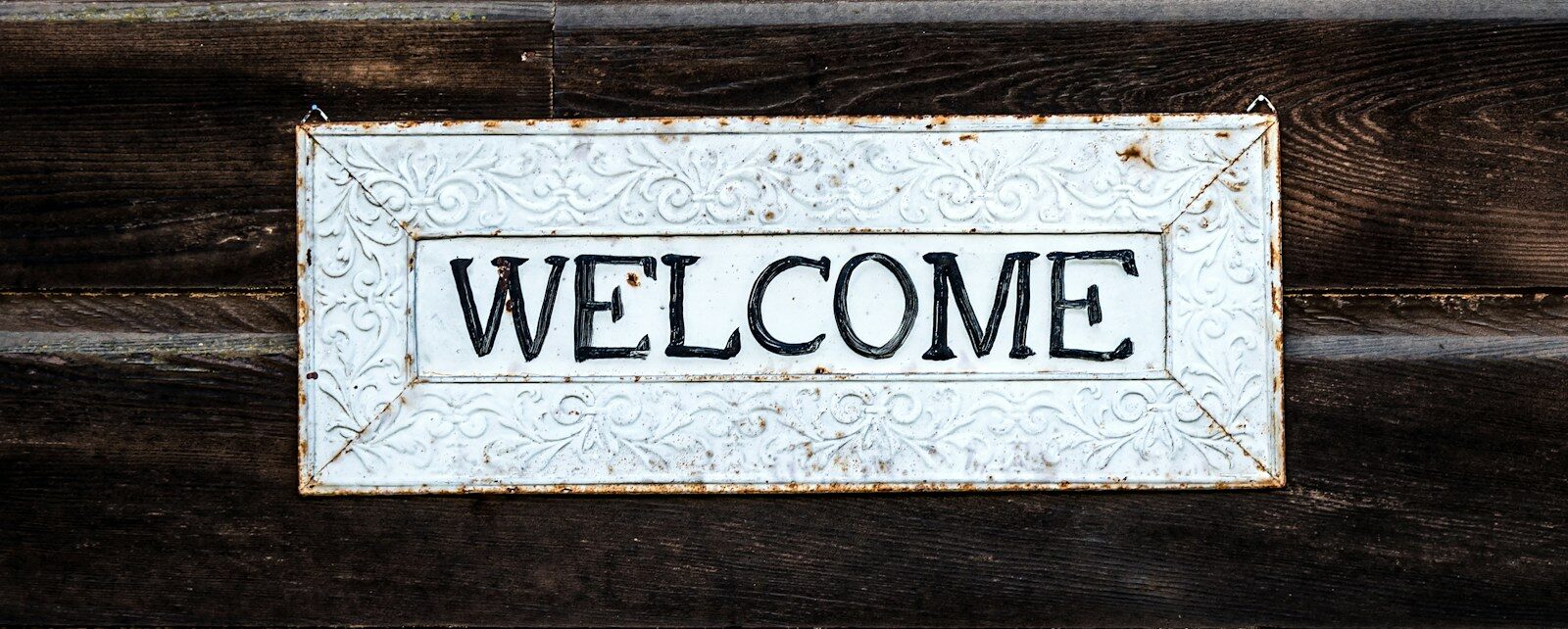 black and white wooden welcome signage