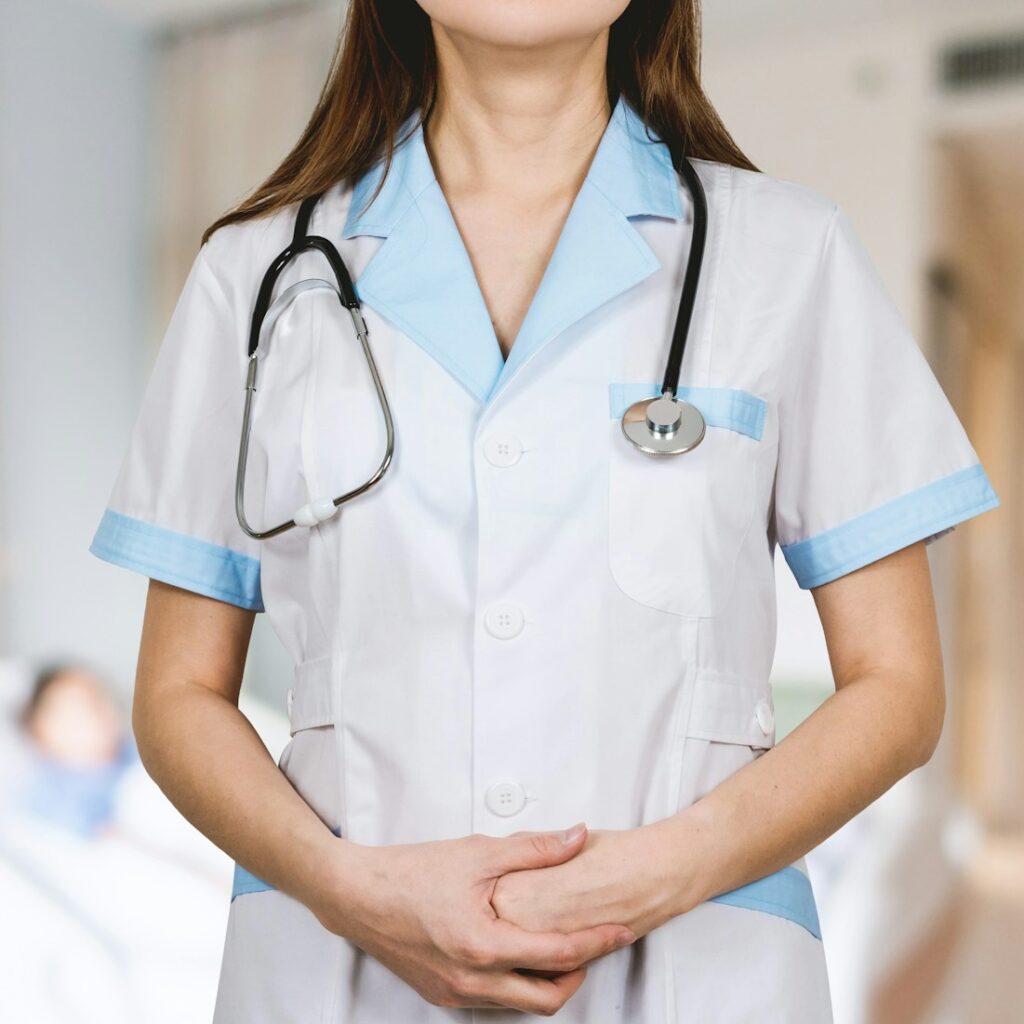 woman in white button up shirt and blue stethoscope