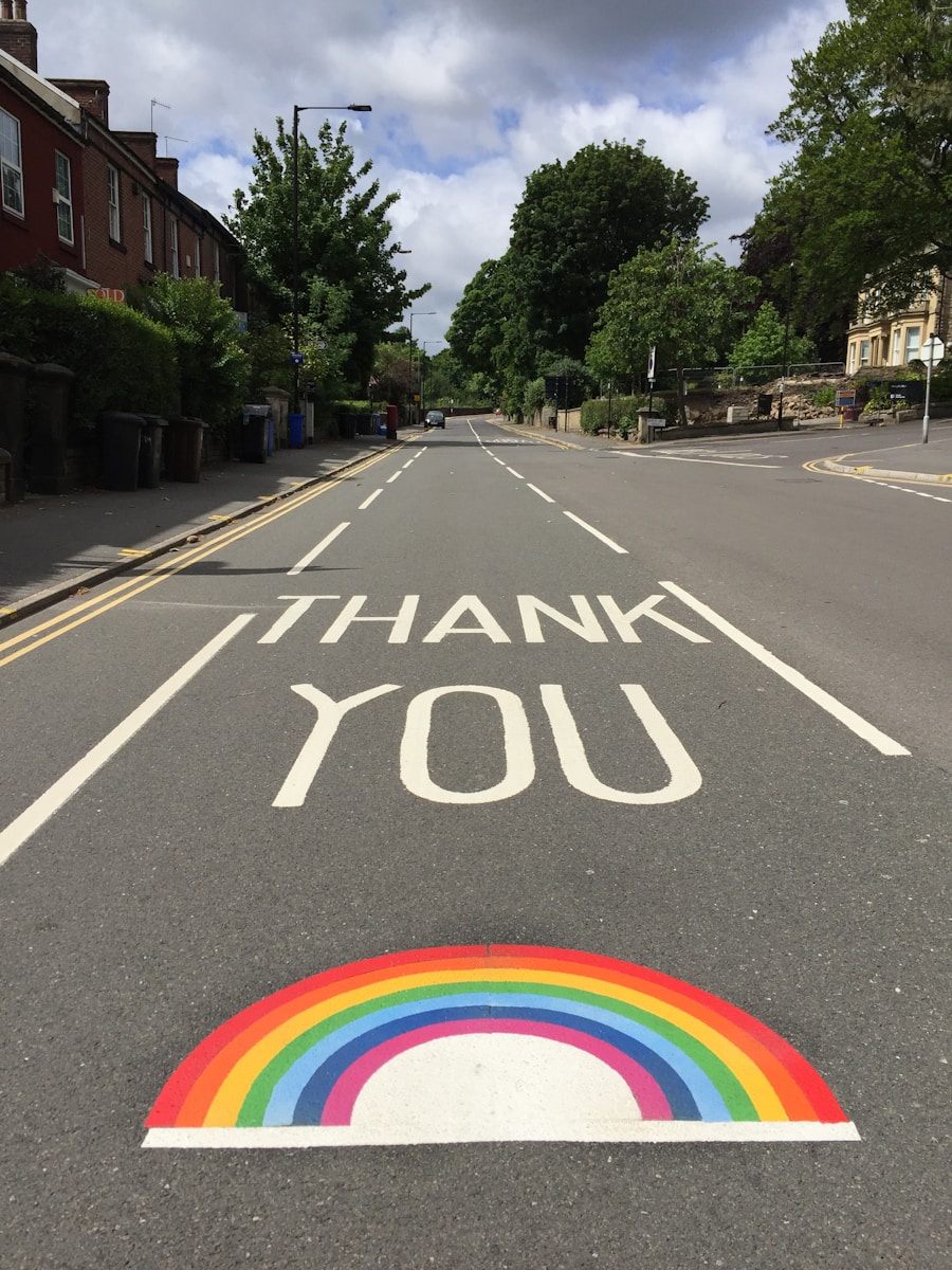 black asphalt road with rainbow sign