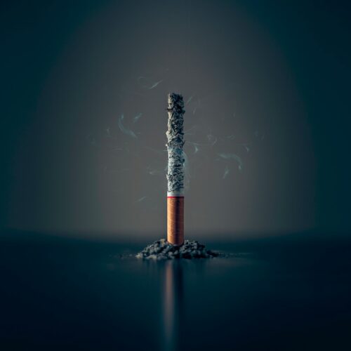 single cigarette stick with ashes stick