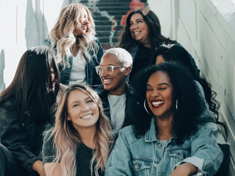 3 women sitting on red carpet